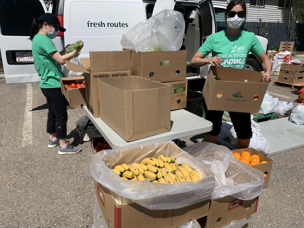 Alex staff unloading fresh produce from a van